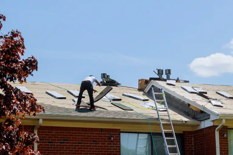 Roofers repairing a house roof