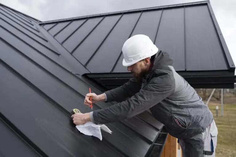 Roofer installing a metal roof panel